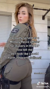 Natalia Fadeev looks back at the camera in a sexy pose. She is wearing a military poliec officer uniform. Text reads: “I proudly served as a Military Police officier for 3 years in the IDF now tell me, do I look like I could harm innocent civilians?”