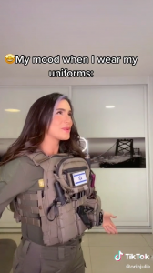 Orin Julie wears an IDF uniform with an Israeli flag patch sewed on her chest garment. She appears happy. Text reads: “My mood when I wear my uniforms:”